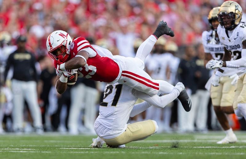 Colorado's Shilo Sanders (21) upends Nebraska's Dante Dowdell, top left, during the first half of an NCAA college football game Saturday, Sept. 7, 2024, in Lincoln, Neb. (AP Photo/Rebecca S. Gratz)