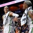 Minnesota Lynx forward Napheesa Collier, left, slaps hands with guard Courtney Williams, right, in the final seconds of a WNBA basketball semifinal game against the Connecticut Sun, Friday, Oct. 4, 2024, in Uncasville, Conn. (AP Photo/Jessica Hill)