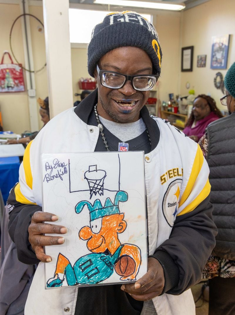 Dave Benefield shows off his artwork. at the Friendship Center of Atlanta.
 PHIL SKINNER FOR THE ATLANTA JOURNAL-CONSTITUTION