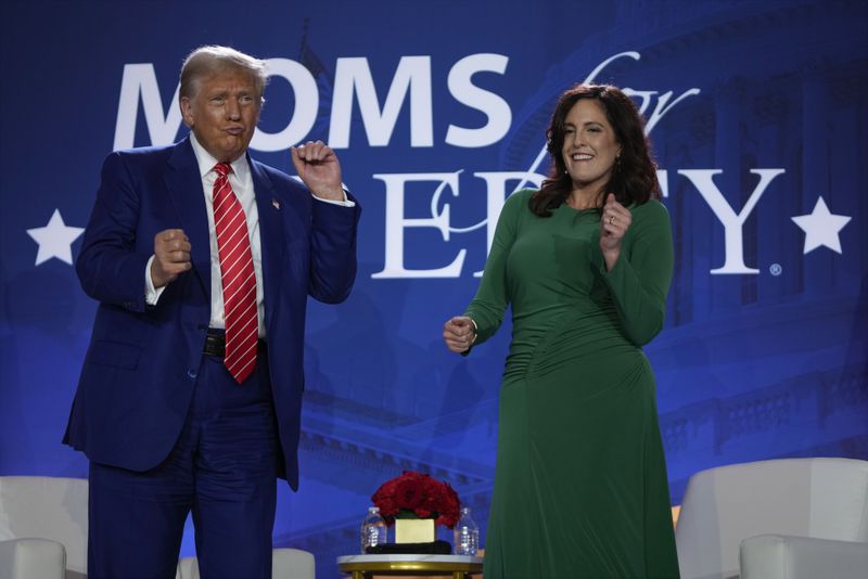 Republican presidential nominee former President Donald Trump dances with Moms for Liberty co-founder Tiffany Justice during an event at the group's annual convention in Washington, Friday, Aug. 30, 2024. (AP Photo/Mark Schiefelbein)