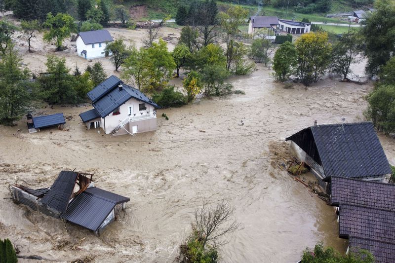 Flooded houses after a heavy rain in the village of Luke, near Bosnian town of Fojnica, 50 kms west of Sarajevo, Bosnia, Friday, Oct. 4, 2024. (AP Photo/Robert Oroz)