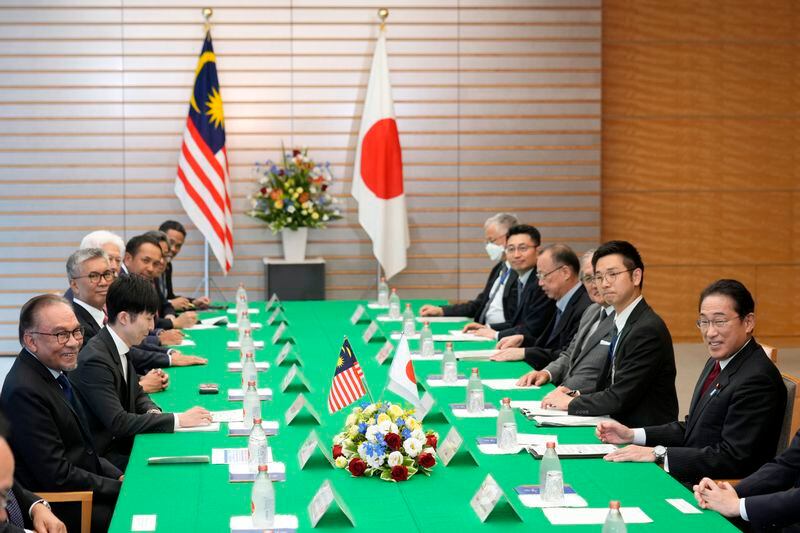 Japanese Prime Minister Fumio Kishida, right, and Malaysian Prime Minister Anwar Ibrahim, left, take a seat at the start of their meeting at the prime minister's office in Tokyo, Thursday, May 23, 2024. (Franck Robichon/Pool Photo via AP)