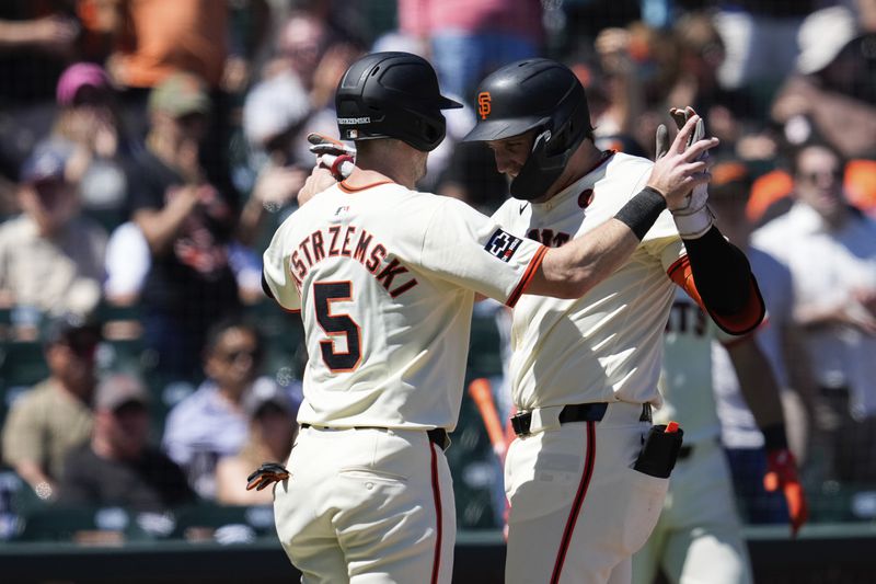 San Francisco Giants' Casey Schmitt, right, celebrates with Mike Yastrzemski after hitting a two-run home run against the Atlanta Braves during the sixth inning of a baseball game Thursday, Aug. 15, 2024, in San Francisco. (AP Photo/Godofredo A. Vásquez)