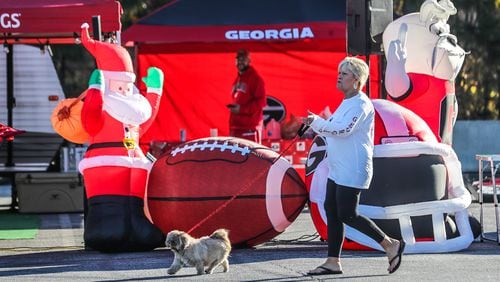 Thomaston resident Janet Pitts walks her dog Annie in the sunshine Friday at the Marshalling Yard at the Georgia World Congress Center.