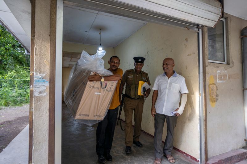 Polling officials carry a sealed ballot box as they return it to a counting center at the end of voting during presidential election in Colombo, Sri Lanka, Saturday, Sept. 21, 2024. (AP Photo/Rajesh Kumar Singh)