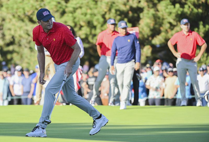 United States team member Keegan Bradley reacts after a putt on the 18th green during a fifth-round singles match at the Presidents Cup golf tournament at Royal Montreal Golf Club, Sunday, Sept. 29, 2024, in Montreal. (Graham Hughes/The Canadian Press via AP)