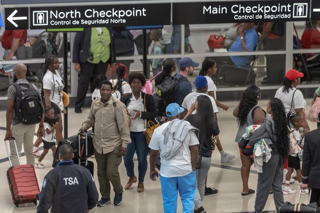 Airport customer service workers move travelers through the North side of the domestic terminal on Friday, Aug. 30, 2024 as the last hurrah of the summer saw yet another packed weekend at Hartsfield-Jackson International Airport. The peak day was expected to be Friday, when more than 349,000 people were expected to travel to, from or through the Atlanta airport. (John Spink/AJC)