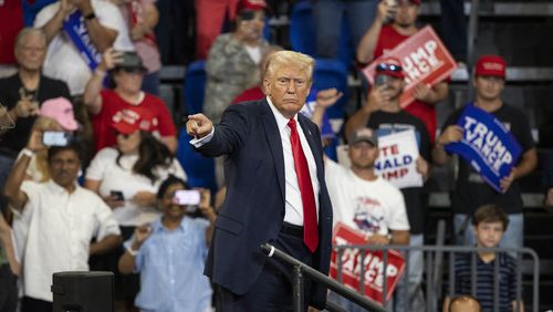 Former President and 2024 Republican presidential candidate Donald Trump points to the crowd as he leaves after speaking during a campaign rally at the Georgia State University Convocation Center on Saturday, Aug. 3, 2024, in Atlanta. (Christian Monterrosa/AFP/Getty Images/TNS)