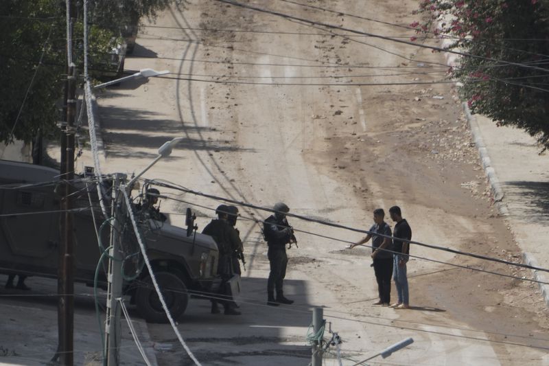 Members of the Israeli forces check Palestinians leaving the West Bank Jenin refugee camp during a military operation, Saturday, Aug. 31, 2024. (AP Photo/Majdi Mohammed)