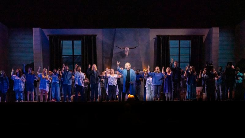 This image released by Opera Philadelphia shows Kevin Burdette, center, and the cast during a performance of "The Listeners." (Steven Pisano/Opera Philadelphia via AP)