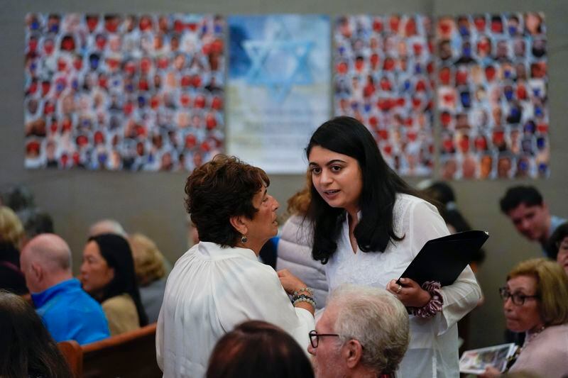 Writer Lulu Fairman, left, talks with writer and co-producer Maryam Chishti before a performance of "What Do I Do With All This Heritage?" on Wednesday, May 22, 2024, in Los Angeles. The show offers more than 14 true stories of Asian American Jews. (AP Photo/Ashley Landis)