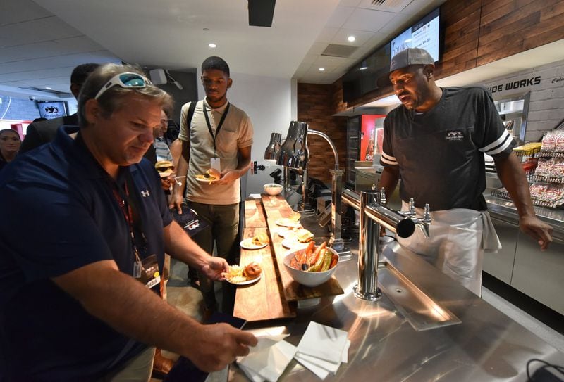 August 15, 2017 Atlanta - Deontra Hambrick (right) helps tour participants at The West Nest concession stand during a tour of Mercedes-Benz Stadium on Tuesday, August 15, 2017. The West Nest is part of Westside Works, a program started by the Arthur Blank Family Foundation as part of an attempt to turn around Vine City and English Avenue, two of the city’s poorest neighborhoods. HYOSUB SHIN / HSHIN@AJC.COM