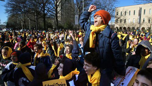 January 31, 2013 - Atlanta, Ga: Yehuda Benschitrit, 14, cheers as the name of his school, Torah Day School of Altanta, is announced as one of many schools that participated in the Georgia School Choice Celebration and Rally at the west entrance to the Georgia State Capitol Thursday morning in Atlanta, Ga., January 31, 2013. Benschitrit, an 8th grade student at Torah Day School of Atlanta, is sitting on the shoulders of fellow 8th grade student, Ben Bogart, 14. More than 2,000 public, private, and home school students met outside the Georgia State Capitol Thursday to call for the expansion of educational opportunities for kids. This is the fourth annual Georgia School Choice Celebration and Rally. JASON GETZ / JGETZ@AJC.COM