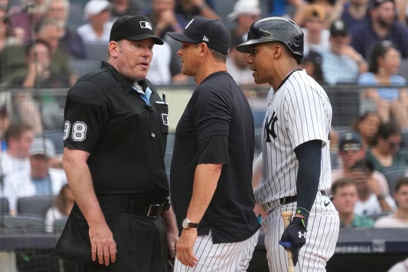 New York Yankees' Juan Soto, right, argues with umpire Chris Conroy, left, after being called out on strikes during the eighth inning of a baseball game against the Atlanta Braves, Sunday, June 23, 2024, in New York. (AP Photo/Pamela Smith)