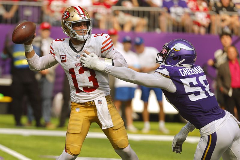 San Francisco 49ers quarterback Brock Purdy (13) throws a pass as he is pressured by Minnesota Vikings linebacker Jonathan Greenard (58) during the second half of an NFL football game, Sunday, Sept. 15, 2024, in Minneapolis. The Vikings won 23-17. (AP Photo/Bruce Kluckhohn)