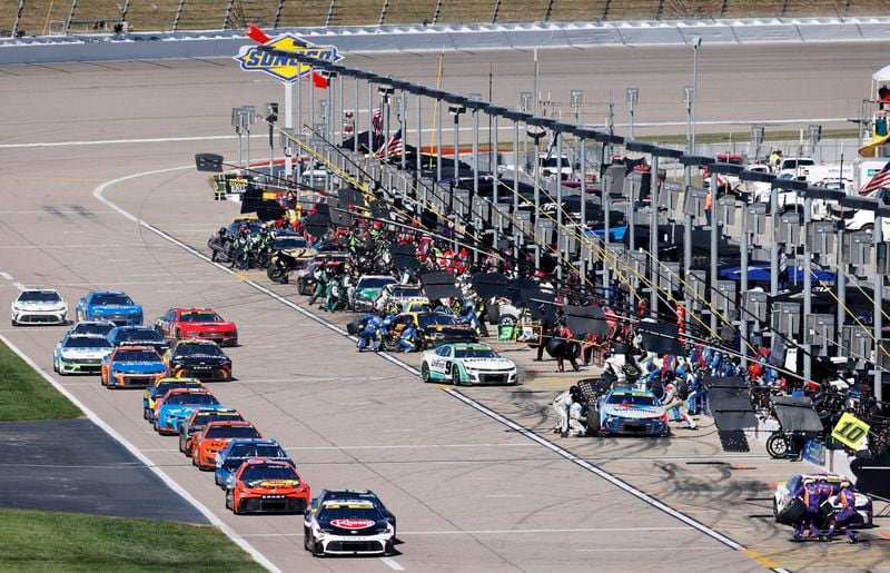 Drivers stop on pit road at the end of the first stage during a NASCAR Cup Series auto race at Kansas Speedway in Kansas City, Kan., Sunday, Sept. 29, 2024. (AP Photo/Colin E. Braley)