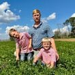 Peanut farmer Riley Davis sits in a peanut field along the Webster County border south of Plains with his sons, Drew (left), 4, and Luke, 7. (Joe Kovac Jr./AJC)