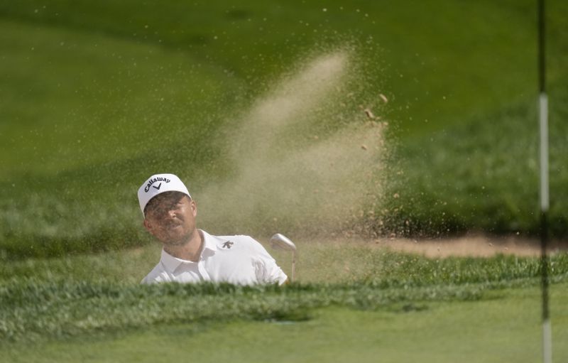 Xander Schauffele hits out of a bunker onto the 17th green during the second round of the BMW Championship golf event at Castle Pines Golf Club, Friday, Aug. 23, 2024, in Castle Rock, Colo. (AP Photo/Matt York)