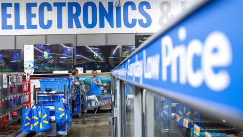 FILE - People walk around a Walmart Superstore in Secaucus, New Jersey, on July 11, 2024. (AP Photo/Eduardo Munoz Alvarez, File)