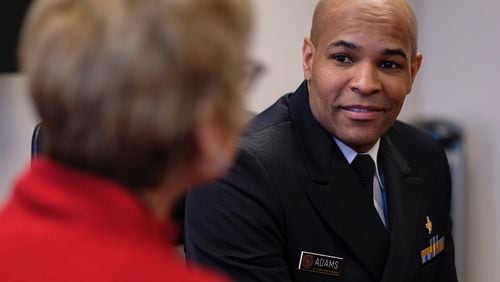 Surgeon General Jerome Adams speaks with State Public Health Commissioner Dr. Kathleen Toomey on Friday, March, 2020 in Atlanta.