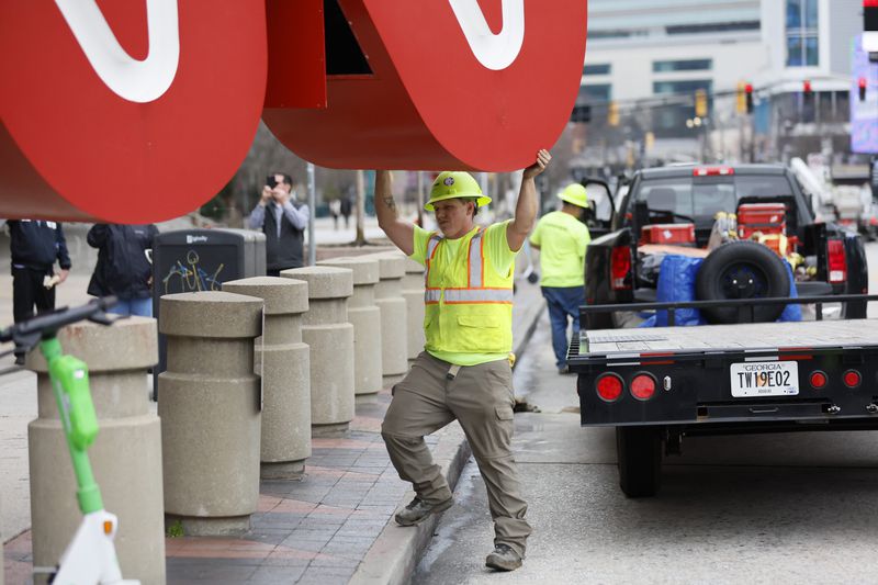 A crew worker is seen helping direct the 12-foot, red-and-white CNN sign to a flatbed truck after being removed from its base, CNN Center, on Monday, March 2024. The famous symbol will be refurbished and will find its new home at the Techwood campus by the Warner Brothers studios in Midtown.
Miguel Martinez /miguel.martinezjimenez@ajc.com