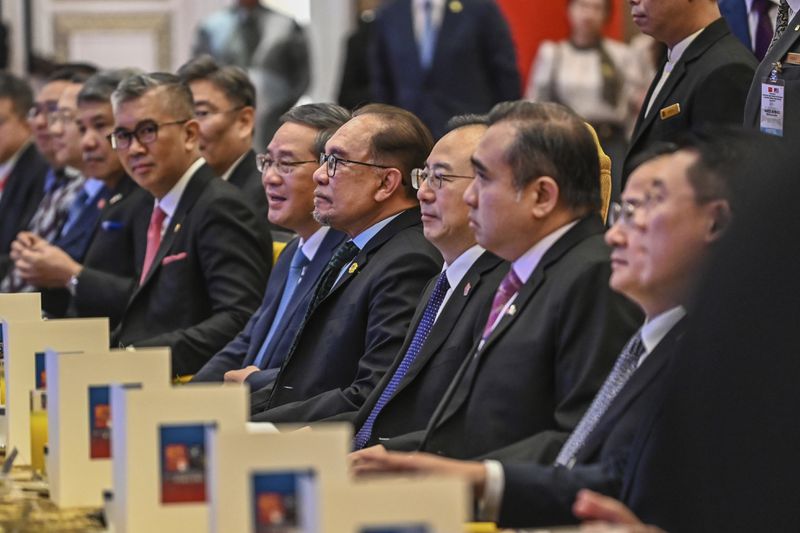 In this photo released by Malaysia's Department of Information, China's Premier Li, center left, and Malaysian Prime Minister Anwar Ibrahim, center right, attend during a business luncheon at a hotel in Kuala Lumpur, Malaysia, Thursday, June 20, 2024. (Malaysia's Department of Information via AP)