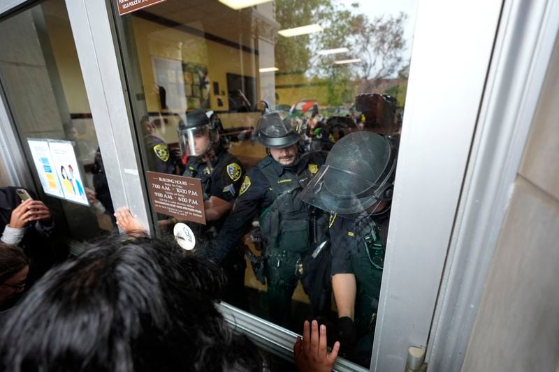 Police block a doorway to pro-Palestinian demonstrators at Dodd Hall on the UCLA campus on Thursday, May 23, 2024, in Los Angeles. (AP Photo/Ryan Sun)