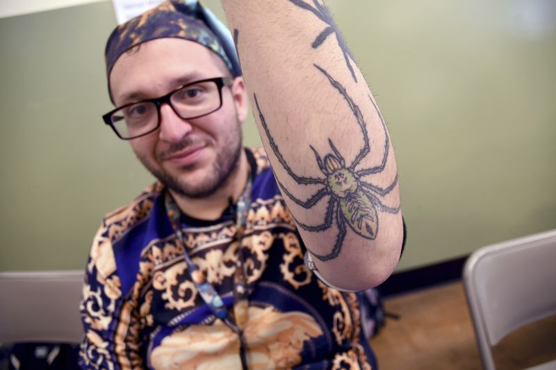 Goran Shikak, an arachnology graduate student at The University of Colorado Denver, shows off his spider tattoos during the Tarantula Festival in La Junta, Colo., Saturday, Sept. 28, 2024. (AP Photo/Thomas Peipert)