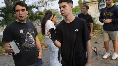 University students show their phone screens after social media platform X was blocked nationwide, in Rio de Janeiro, Monday, Sept. 2, 2024. (AP Photo/Silvia Izquierdo)