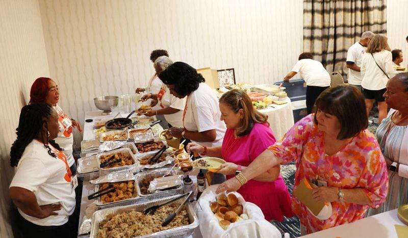 Reunion attendees grab food in the buffet at the Central High School class of 1974 50th reunion on Friday, June 21, 2024, at the Wingate by Wyndham Macon in Macon, Georgia. (Photo Courtesy of Katie Tucker/The Telegraph)