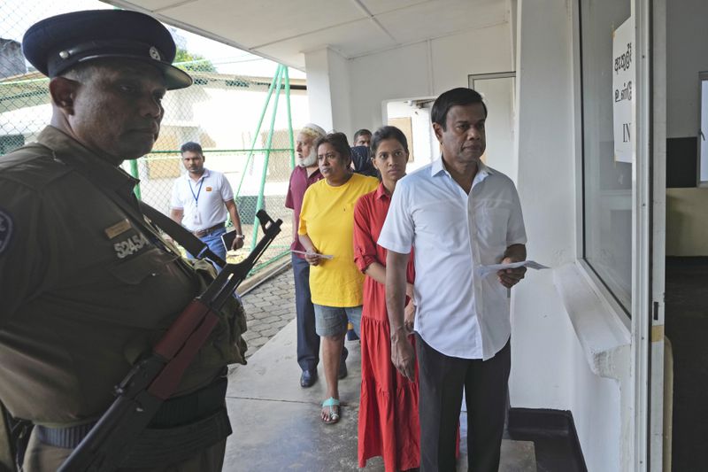 People wait in a queue to casts their votes at a polling station in Colombo, Sri Lanka, Saturday, Sept. 21, 2024. (AP Photo/Rajesh Kumar Singh)