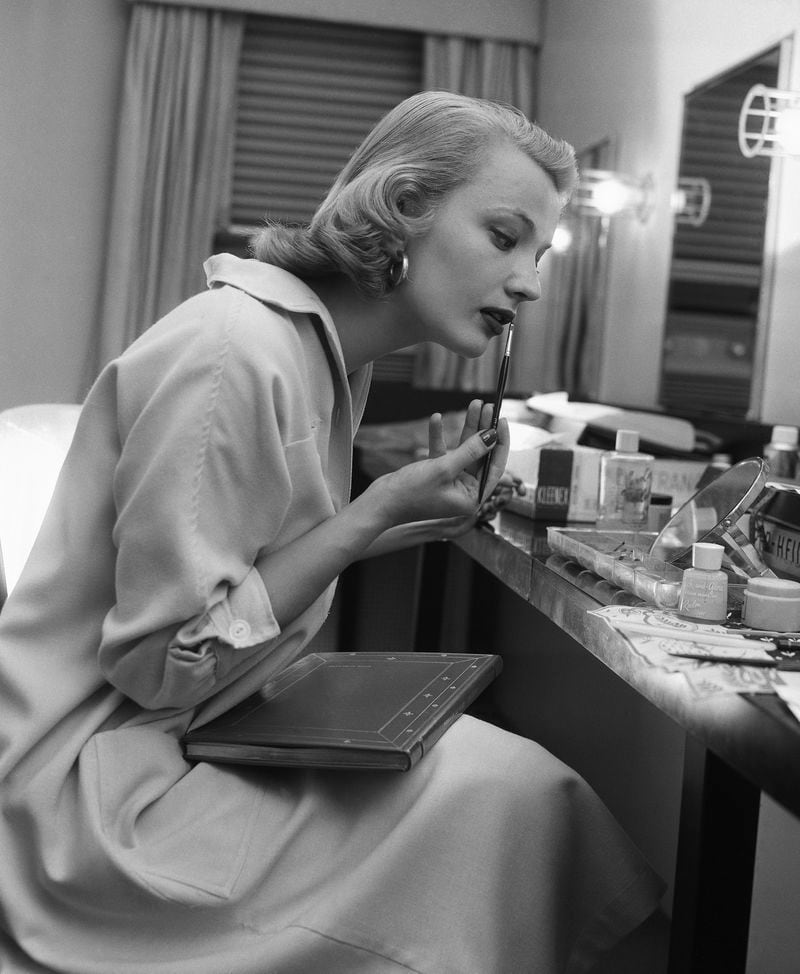 FILE - Actor Gena Rowlands, puts on make-up in her dressing room for her role as leading lady in "Middle of the Night", in New York on Nov. 21, 1956. Rowlands is suffering from Alzheimer’s disease, says her son, the filmmaker Nick Cassavetes. Cassavetes, in an interview with Entertainment Weekly published Tuesday, says Rowlands has had Alzheimer’s for five years. (AP Photo/Hans von Nolde, File)