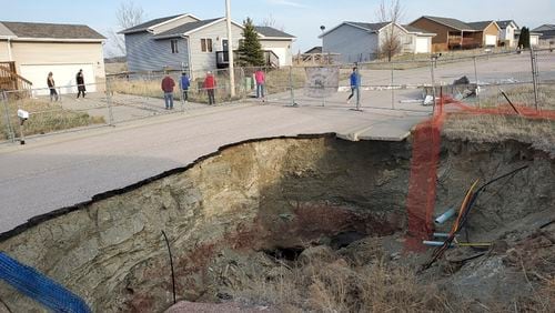 This photo taken April 27, 2022, by Tonya Junker shows a sinkhole in the Hideaway Hills neighborhood near Rapid City, S.D. (Tonya Junker via AP)