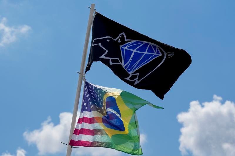 Flags fly over the Pig Damonds barbecue team's tent at the World Championship Barbecue Cooking Contest, Friday, May 17, 2024, in Memphis, Tenn. The team is made up of members from the United States and Brazil. (AP Photo/George Walker IV)