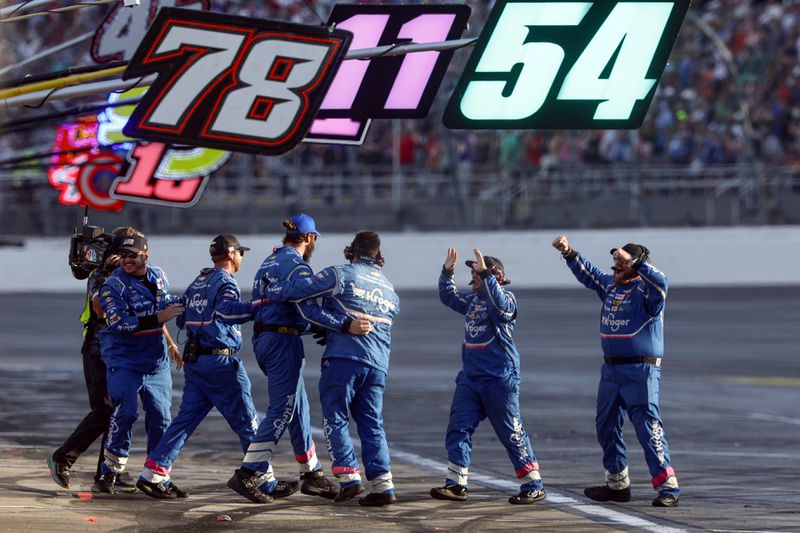 Driver Ricky Stenhouse Jr.'s pit crew celebrates after the win during a NASCAR Cup Series auto race at Talladega Superspeedway, Sunday, Oct. 6, 2024, in Talladega, Ala. (AP Photo/ Butch Dill)