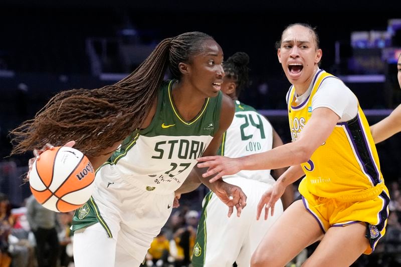 Seattle Storm center Ezi Magbegor, left, drives by Los Angeles Sparks forward Dearica Hamby during the first half of a WNBA basketball game, Wednesday, Sept. 11, 2024, in Los Angeles. (AP Photo/Mark J. Terrill)