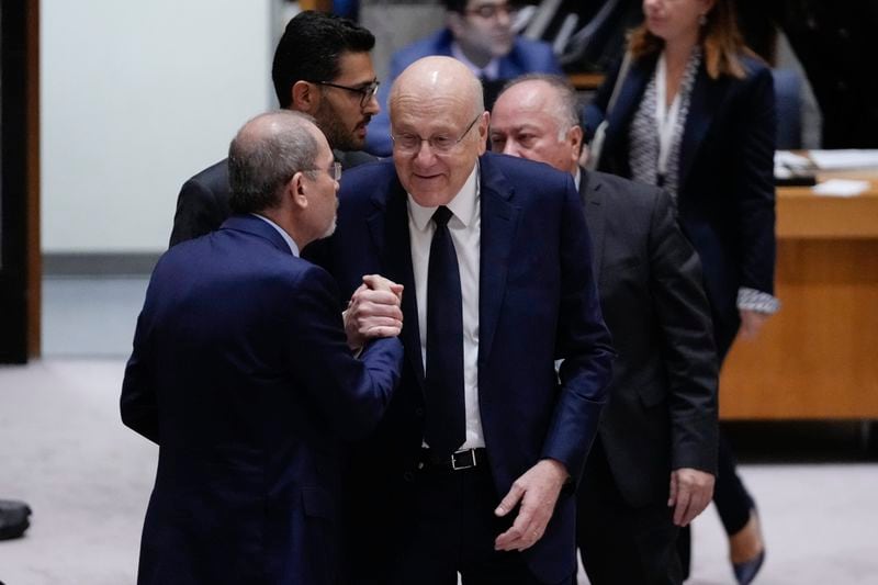 Lebanon's Prime Minister Najib Mikati, center, greets colleagues as he arrives for a Security Council meeting, Wednesday, Sept. 25, 2024, at U.N. headquarters. (AP Photo/Frank Franklin II)