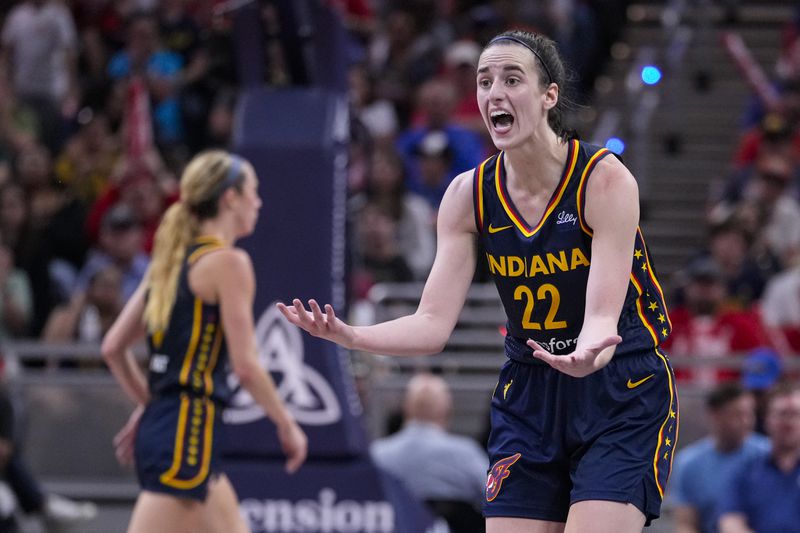 Indiana Fever guard Caitlin Clark (22) questions the lack of a foul in the second half of a WNBA basketball game against the Dallas Wings in Indianapolis, Sunday, Sept. 15, 2024. (AP Photo/Michael Conroy)