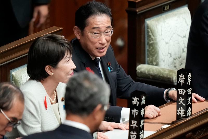 Japanese outgoing Prime Minister Fumio Kishida, right, and Economic Security Minister Sanae Takaichi talk ahead of the extraordinary session of parliament's lower house Tuesday, Oct. 1, 2024, in Tokyo. (AP Photo/Eugene Hoshiko)