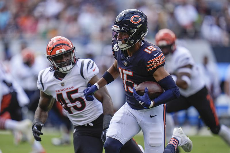 Chicago Bears wide receiver Rome Odunze (15) runs with the ball against Cincinnati Bengals linebacker Maema Njongmeta (45) during the first half of an NFL preseason football game, Saturday, Aug. 17, 2024, at Soldier Field in Chicago. (AP Photo/Erin Hooley)