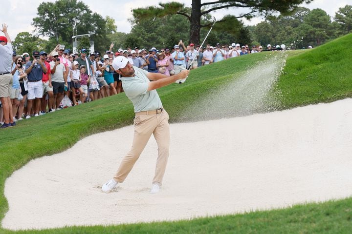 Scottie Scheffler hits the ball out of the bunker in the third green during the final round of the Tour Championship at East Lake Golf Club, Sunday, Sept. 1, 2024, in Atlanta.
(Miguel Martinez / AJC)