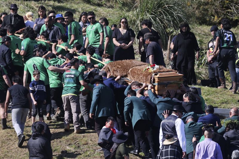 The body of Maori king, Kingi Tuheitia, is carried up Taupiri Mountain for burial at Ngaruawahia, New Zealand, Thursday, Sept 6, 2024. (AP Photo/Alan Gibson)