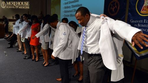 First year medical student Dorian Wood dons his white coat during the Morehouse School of Medicine Annual White Coat Ceremony in this AJC file photo. MSM is one of four Black medical schools in the U.S.