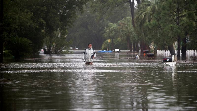 Joey Spalding walks back to his truck down the street where he lives, Monday, Sept. 11, 2017, on Tybee Island, Ga. Spalding just finished repairing his house from nine inches of water after Hurricane Matthew passed the island last year. He said the Tropical Storm Irma brought three feet of storm surge into his living room today. (AP Photo/Stephen B. Morton)