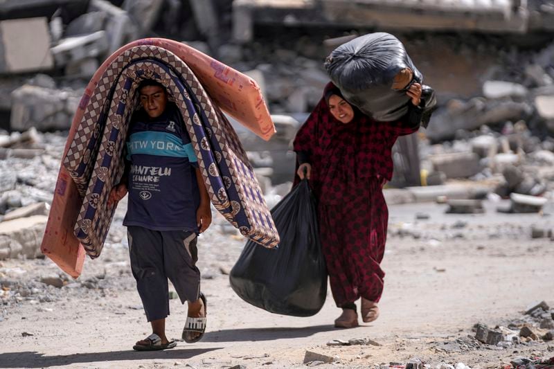 Palestinians displaced by the Israeli air and ground offensive on the Gaza Strip flee from Hamad City, following an evacuation order by the Israeli army to leave parts of the southern area of Khan Younis, Sunday, Aug. 11, 2024. (AP Photo/Abdel Kareem Hana)