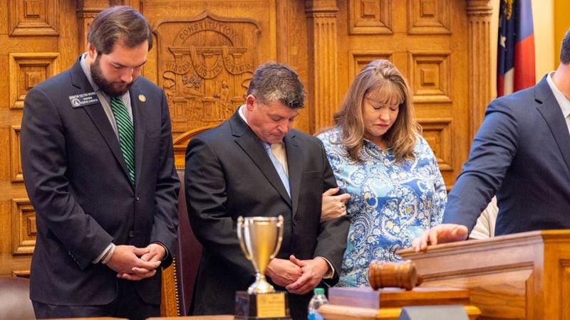 Jason Riley, center, spoke to the state Senate, calling on “Gov. Kemp, please declare an invasion to detain and deport criminal illegals" to prevent tragedies like the one his family suffered in the killing last month of his daughter Laken, a 22-year-old nursing student whose body was found near the University of Georgia. The man charged in her death is a Venezuelan national who authorities say entered the country illegally in 2022. (Arvin Temkar / arvin.temkar@ajc.com)