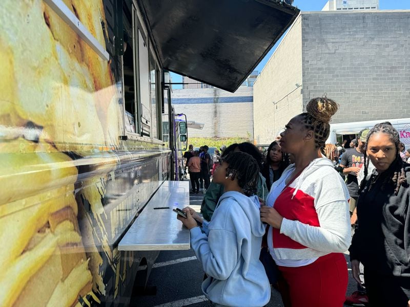 Fans of TikTok food critic Keith Lee wait for free food from food trucks parked at Lee's "community giveback" event in Atlanta on April 3, 2024.