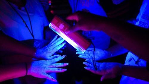 Students have their hands examined to see how effectively they washed them during summer camp at Philadelphia College of Osteopathic Medicine. Georgia’s Opportunities Academy gives Gwinnett high school students interested in future health care careers a chance to learn more about various professions. John Amis/ for the AJC