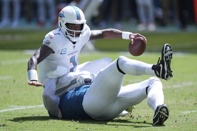 Jacksonville Jaguars defensive end Arik Armstead sacks Miami Dolphins quarterback Tua Tagovailoa (1) during the second half of an NFL football game, Sunday, Sept. 8, 2024, in Miami Gardens, Fla. (AP Photo/Wilfredo Lee)