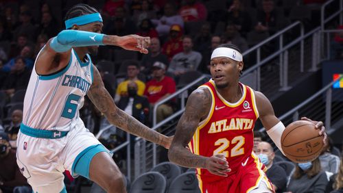 Charlotte Hornets Jalen McDaniels (6) defends against Atlanta Hawks Cam Reddish (22) during the first half of an NBA basketball game Saturday, Nov. 20, 2021, in Atlanta. (AP Photo/Hakim Wright Sr.)